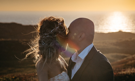 Bride and groom embracing at sunset, wedding season makeup inspiration for bridal events
