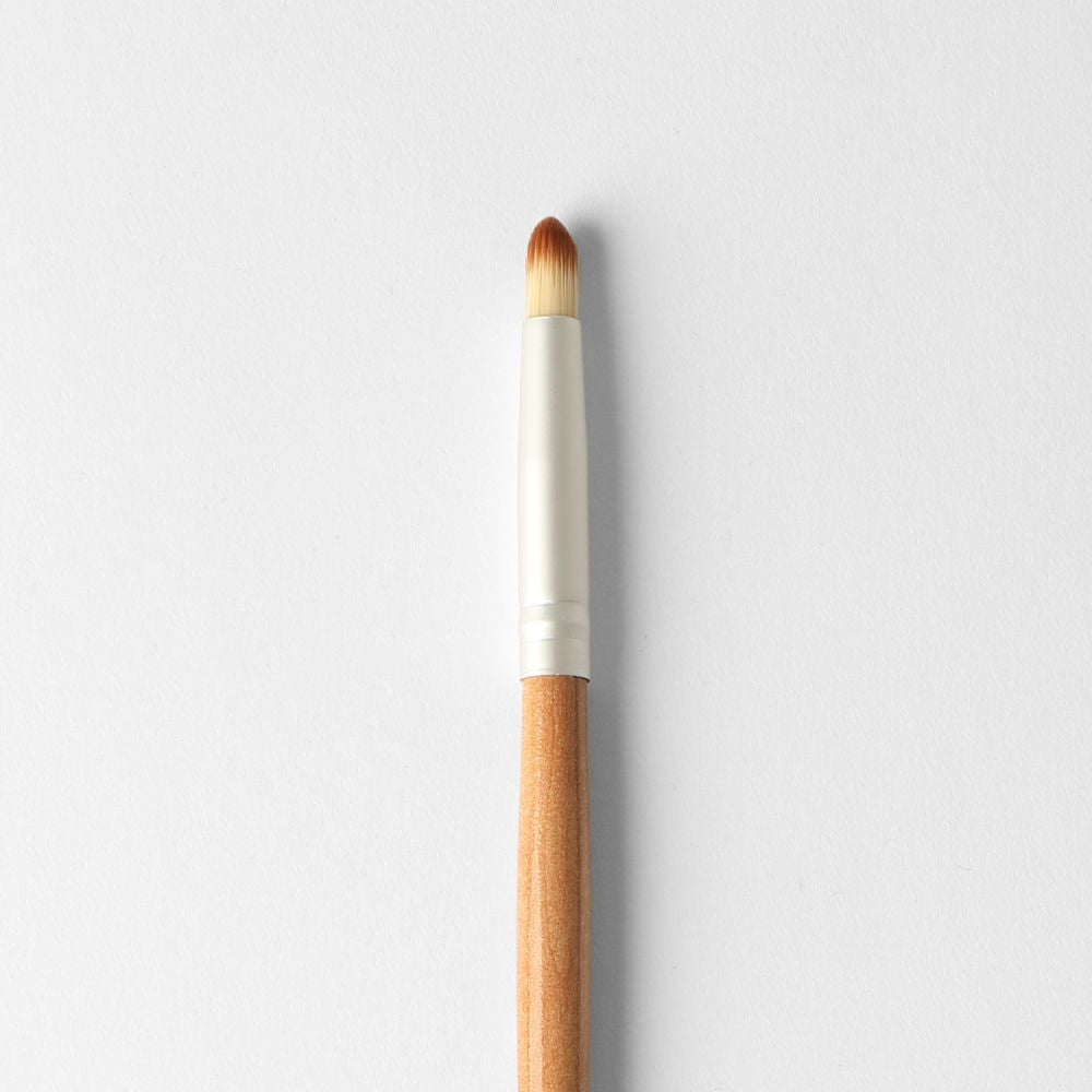 Puzzle Makeup Round Small Eyeshadow Brush close-up - soft vegan bristles for precise eyeshadow application and definition